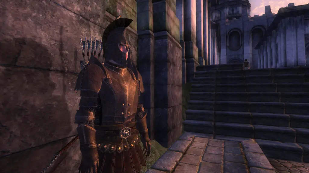Oblivion - A city guard wearing armor and standing on the stone street at sunset