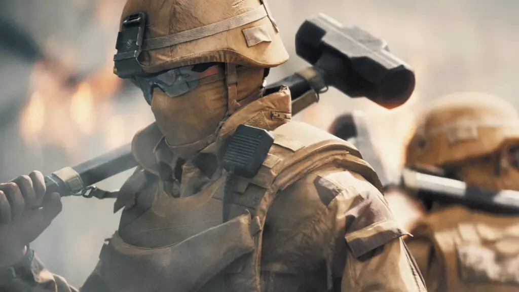 Battlefield 6: A soldier wearing a tan uniform, including a helmet, glasses, and mask, facing to the side with a sledgehammer over their shoulder while turning to look at the camera.