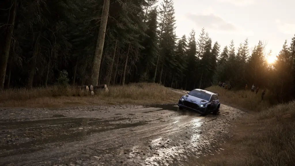 A rally car tears down a muddy track, kicking up dirt, in Assetto Corsa Rally.