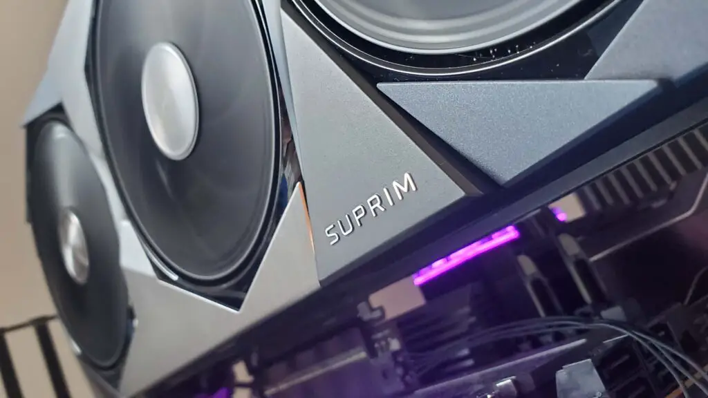 MSI RTX 5090 Suprim SOC graphics card on a grey background with a gradient