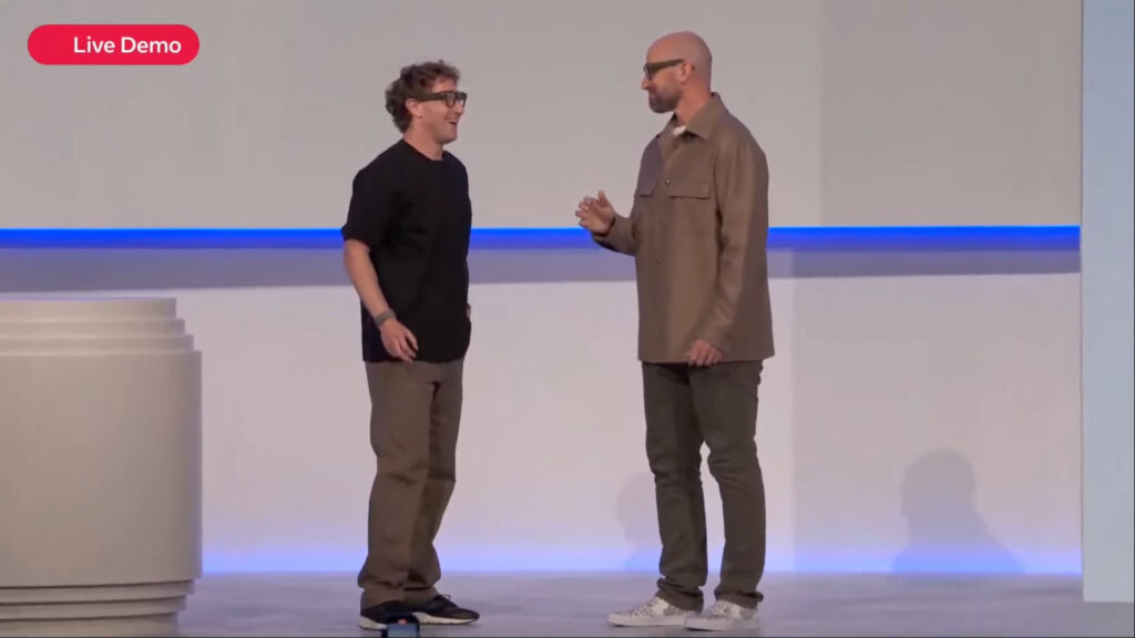 Mark Zuckerberg on stage with "Boz", demonstrating the Meta Ray-Ban smart glasses.