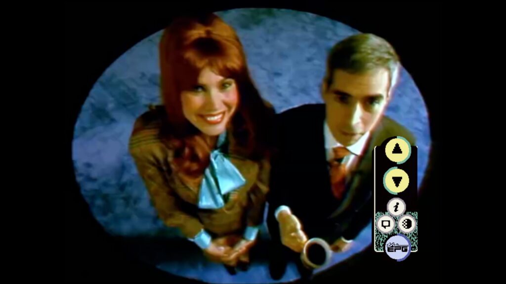 A man and a woman look up into a camera.