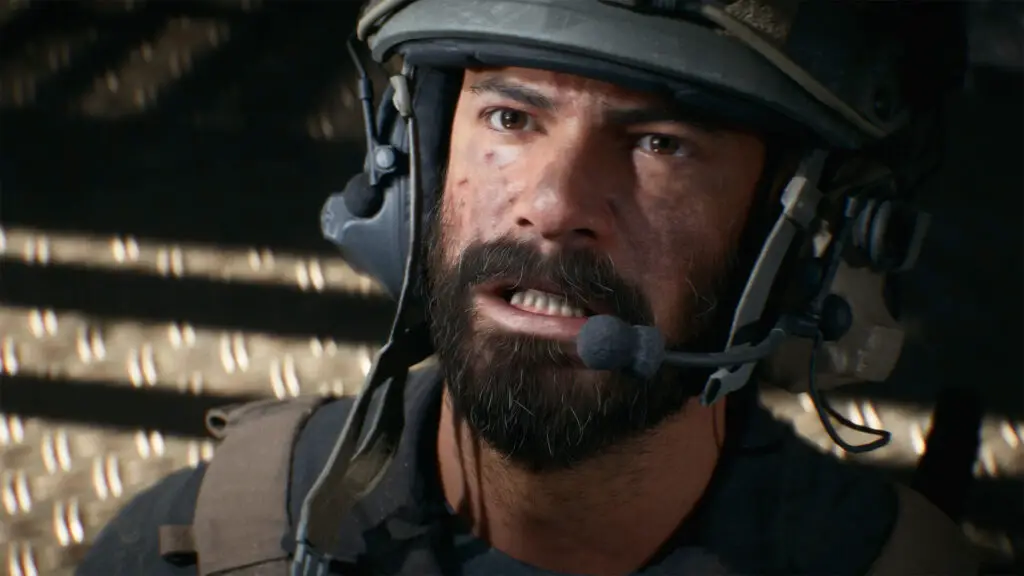 Battlefield 6 beta week 2: A close-up shot of masculine soldier wearing a helmet looking up and gritting his teeth.