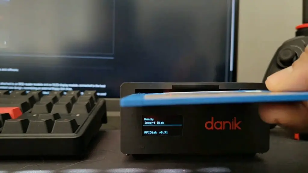 A hand putting a floppy disk into an RFIDisk device.