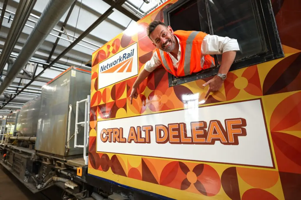 A train driver showing off the name of Network Rail's new leaf buster train, Ctrl Alt Deleaf