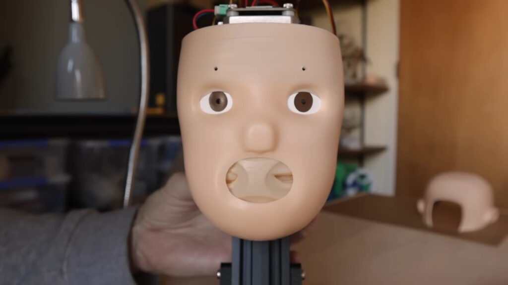 An animatronic doll's head full of mouths, because we have strayed far from God's light