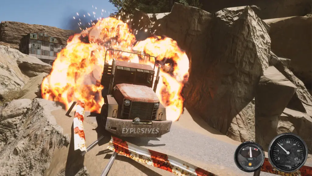 A screenshot of Nitroglycerine! showing a truck exploding on a rocky canyon road, having shattered the red and white barrier that separates the road from a precipitous drop.
