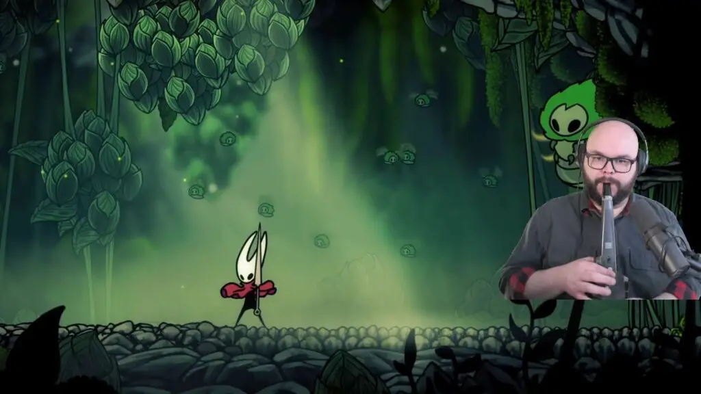 Dr Doot overlaid over a stream of Silksong, playing it with an electric sax.