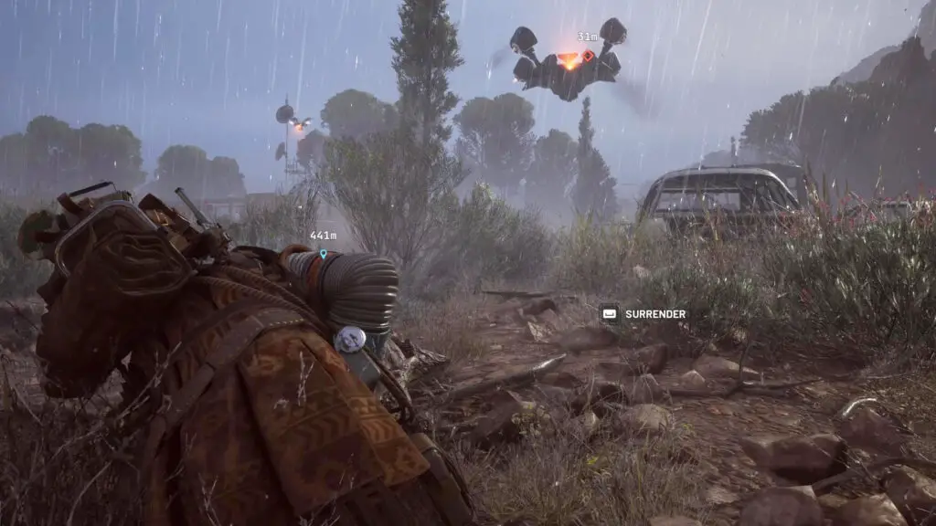 Arc Raiders: A downed player looking up at a Rocketeer hovering over an extract lift near rusted cars.