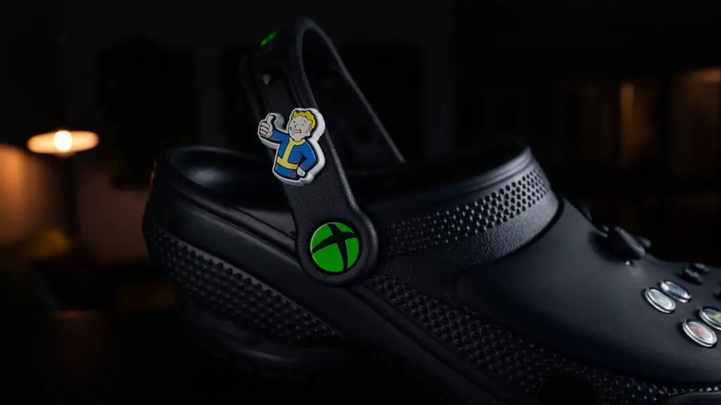 A Vault Boy charm on the side of an Xbox Croc.