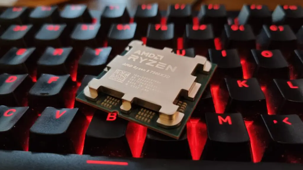 An AMD Ryzen 5 7500X3D CPU on a red-lit gaming keyboard