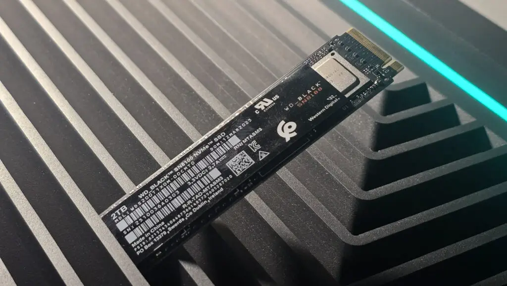 A WD Black SN8100 solid-state drive on a desk, ready for installation.