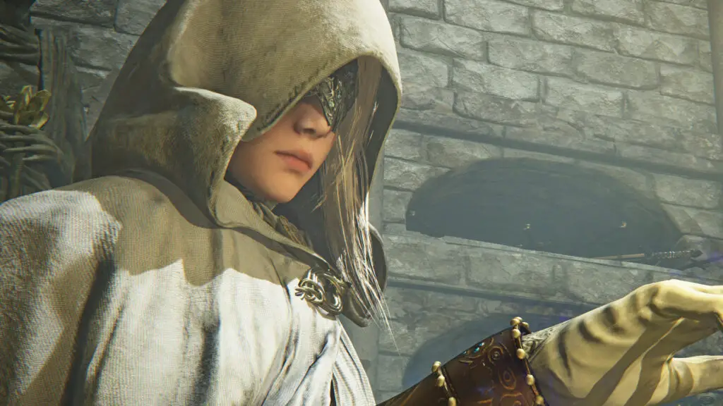 A cloaked Elden Ring Nightreign character lifts her hand and seemingly looks at it despite wearing a mask