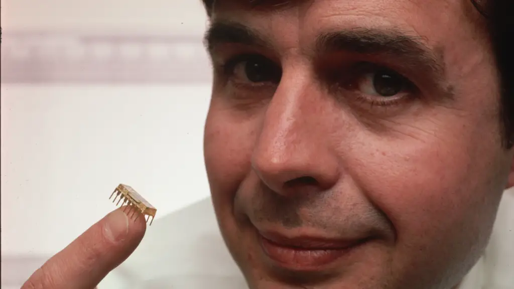 Ward Parkinson, an engineer who founded Micron Technology, Inc. with his twin brother Joe, holds a silicon flake containing 64K of RAM.