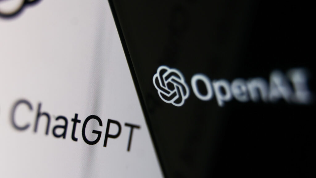 OpenAI logo on a phone and ChatGPT website on a laptop screen, illustrating the company's global reach.