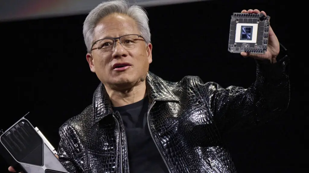 Jensen Huang, co-founder and chief executive officer of Nvidia Corp., speaks while holding the company's new GeForce RTX 50 series graphics cards and a Thor Blackwell robotics processor during the 2025 CES event in Las Vegas, Nevada, US, on Monday, Jan. 6, 2025.