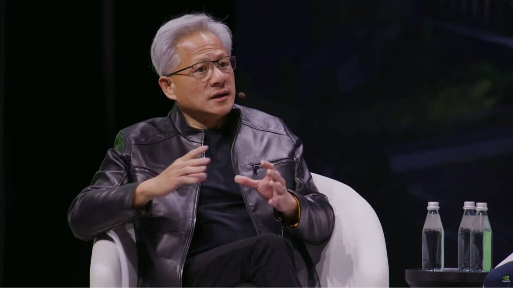 Nvidia's Jensen Huang sitting on a chair, talking to AI CEO panelists at GTC 2026.