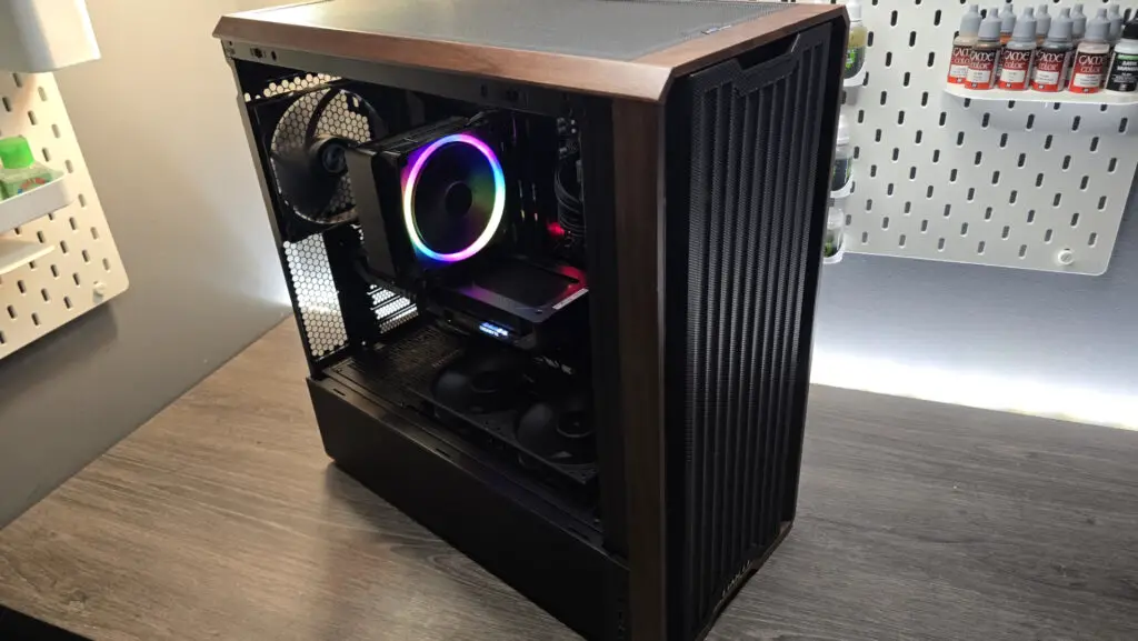 A Lian Li Lancool 217 on a desk with various components installed inside it.