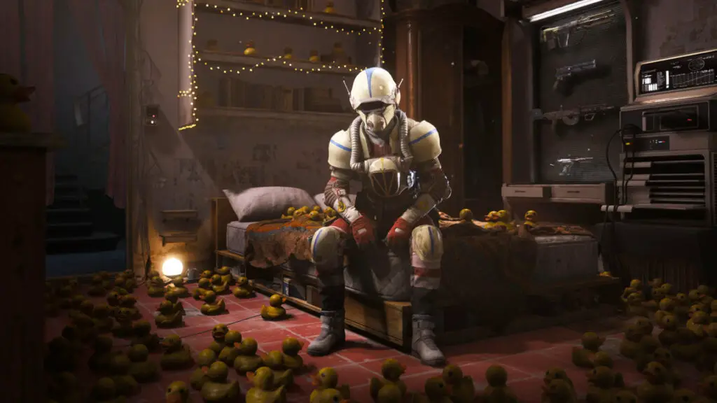 Arc Raiders: A raider wearing white and blue armour sat down on the corner of the den bed surrounded by rubber ducks.