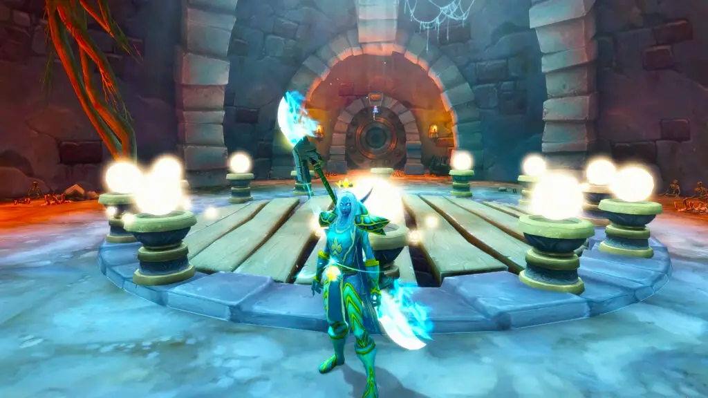 A night elf character stands before a circular stone platform with twelve pedestals in a World of Warcraft dungeon.