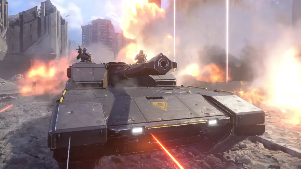A Bastion tank rolling through a city street surrounded by explosions in Helldivers 2.