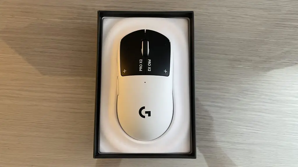 A Logitech G Pro X2 Superstrike gaming mouse on a desk.