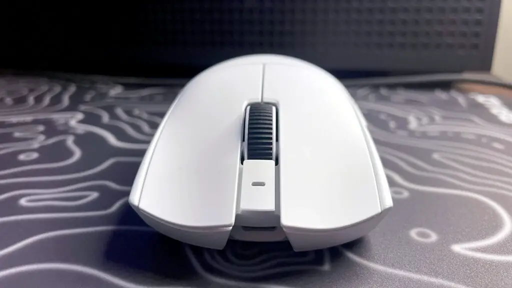 A photo of a white Razer Viper V4 Pro wireless gaming mouse on a colorful mouse pad