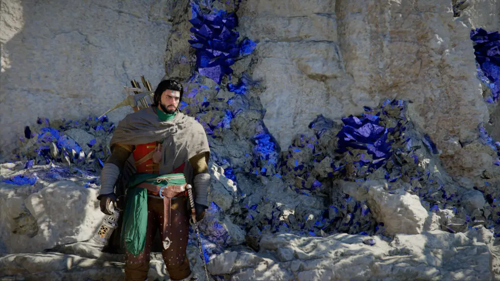 Kliff standing next to a deposit of blue Azurite ore in a cliff.