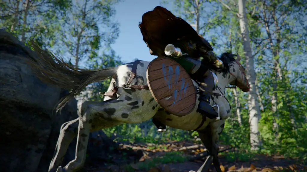 Kliff riding a horse through the wilderness.