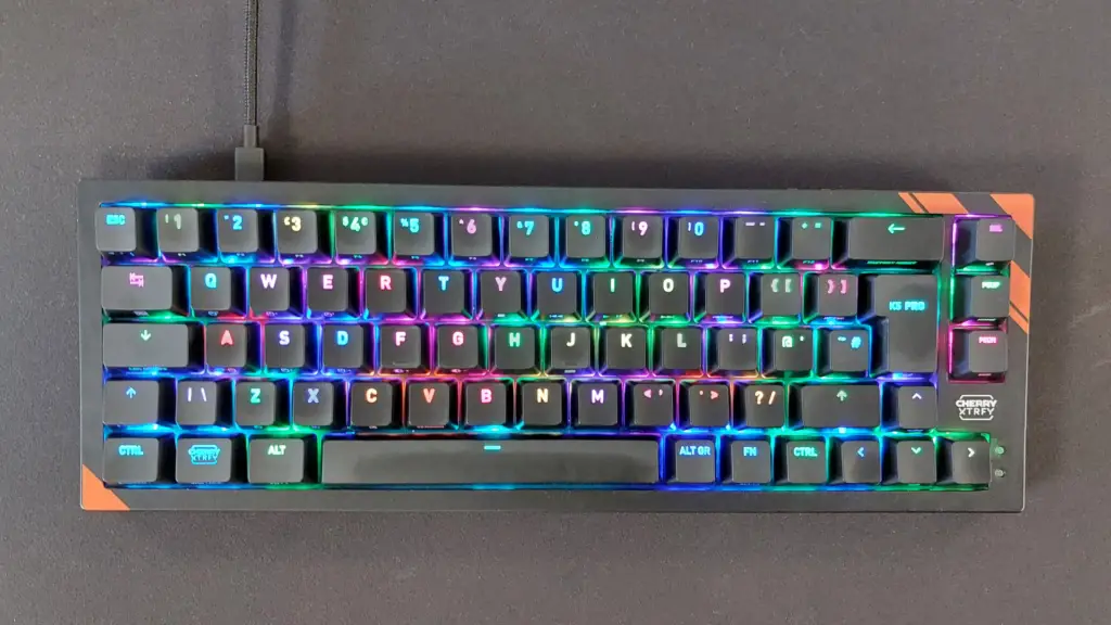 The Cherry K5 Pro TMR Compact on a black mousepad with the RGB lights on.