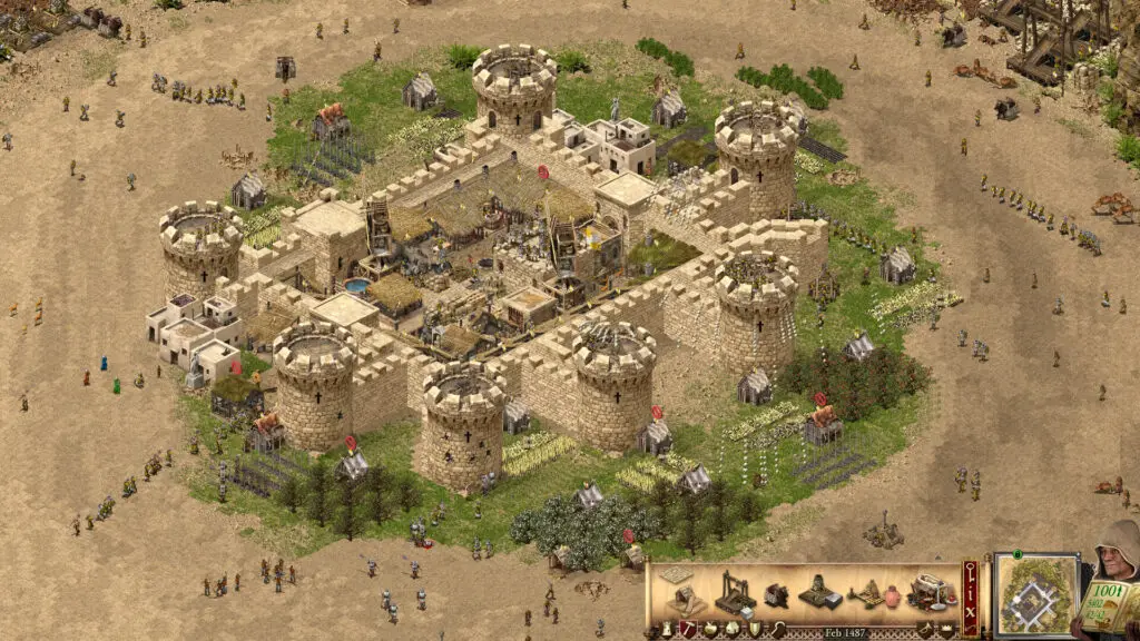 A sprawling sandstone fortress in Stronghold Crusader: Definitive Edition, showcasing worker units and detailed fortifications.