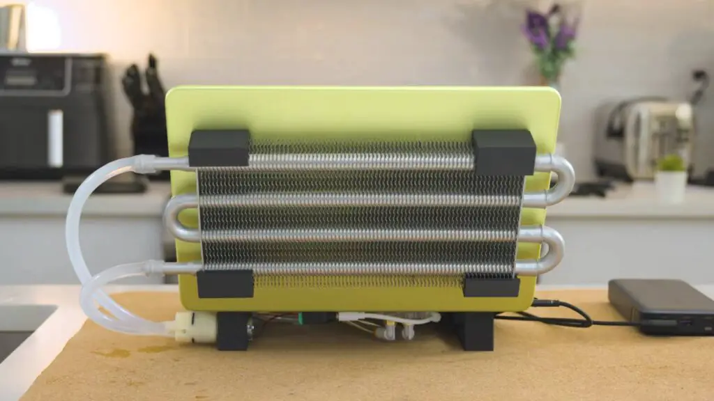 A fully assembled water-cooled MacBook Neo on a tilted stand