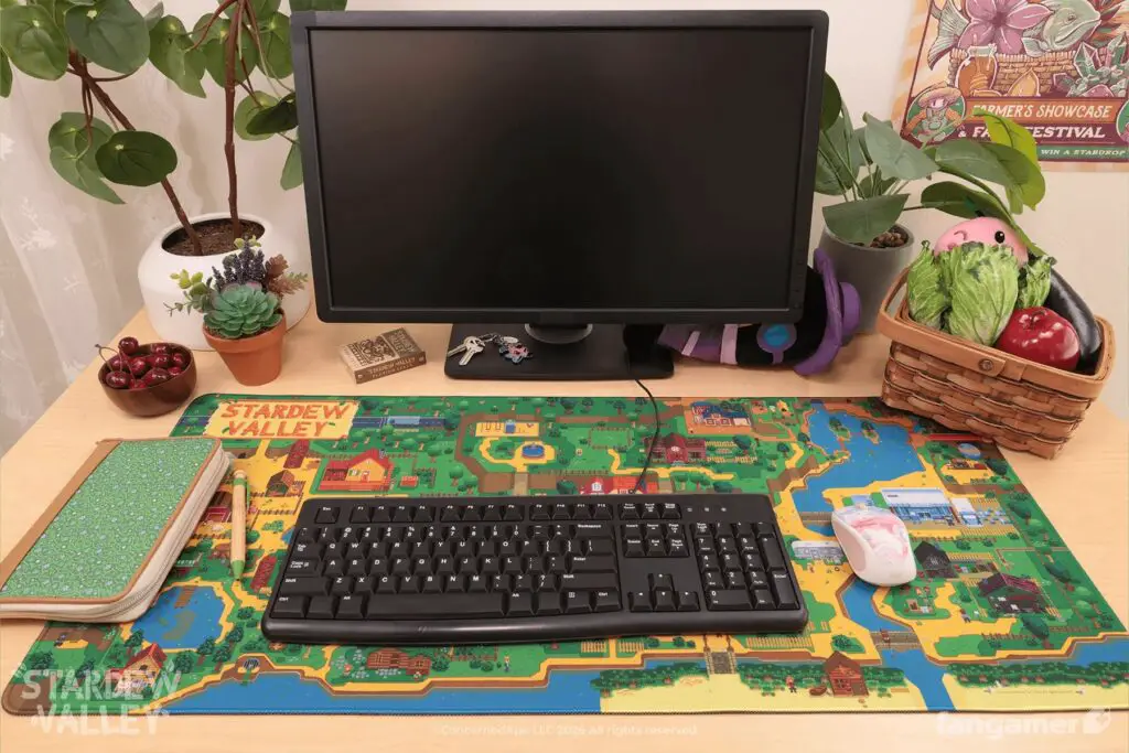 The Stardew Valley Pelican Town desk mat on a desk setup