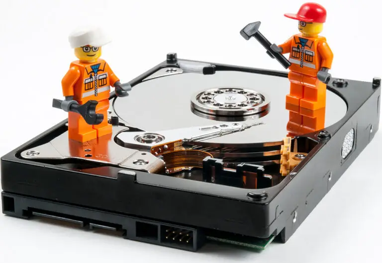 An HDD with Lego figures representing tech maintenance.