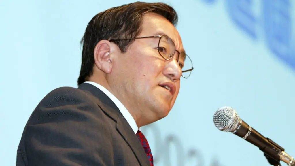 Former Sega President Hideki Sato speaking at a 2002 press conference regarding financial transitions.