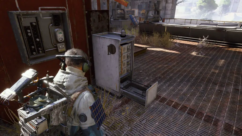 Arc Raiders Worth Your Salt: A player looking at the battery charger machine inside a hangar.