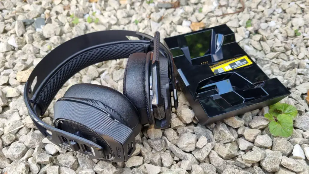 The Nacon Rig 900 Max HS next to its charging stand