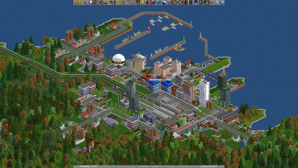 OpenTTD gameplay showing intricate train networks and city growth