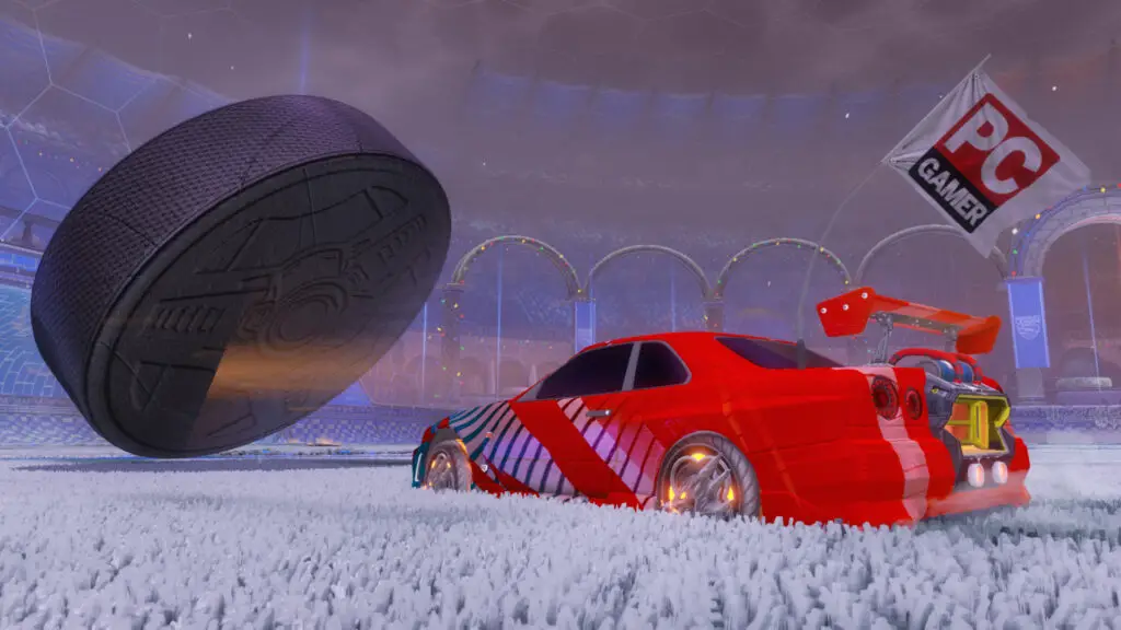 Car hits hockey puck in Rocket League.