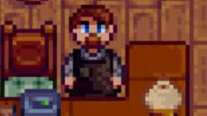 Clint from Stardew Valley, zoomed in as he stands behind the Blacksmith counter