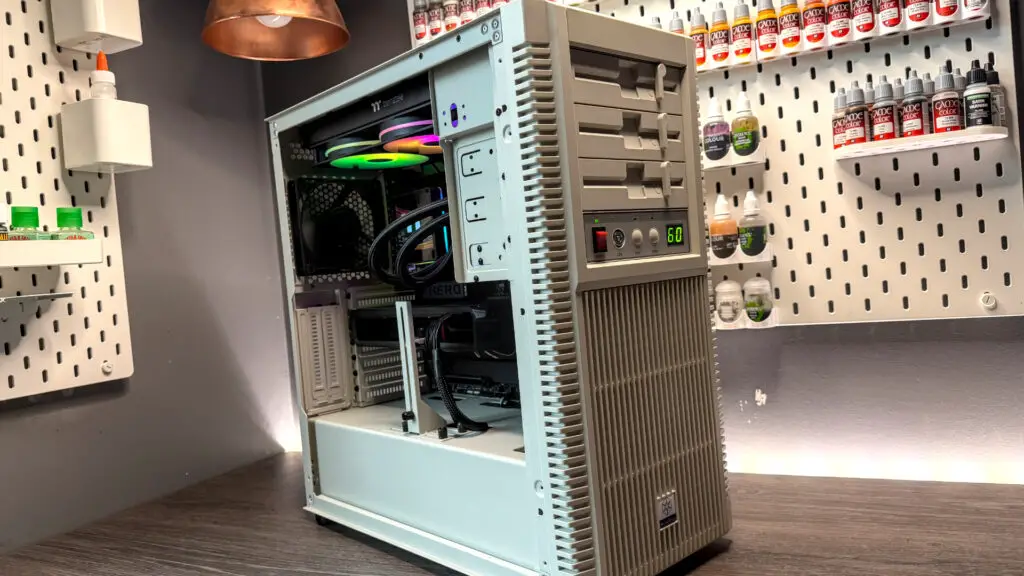 The retro-styled Silverstone FLP02 PC case as a PC is being built into it on a desk.