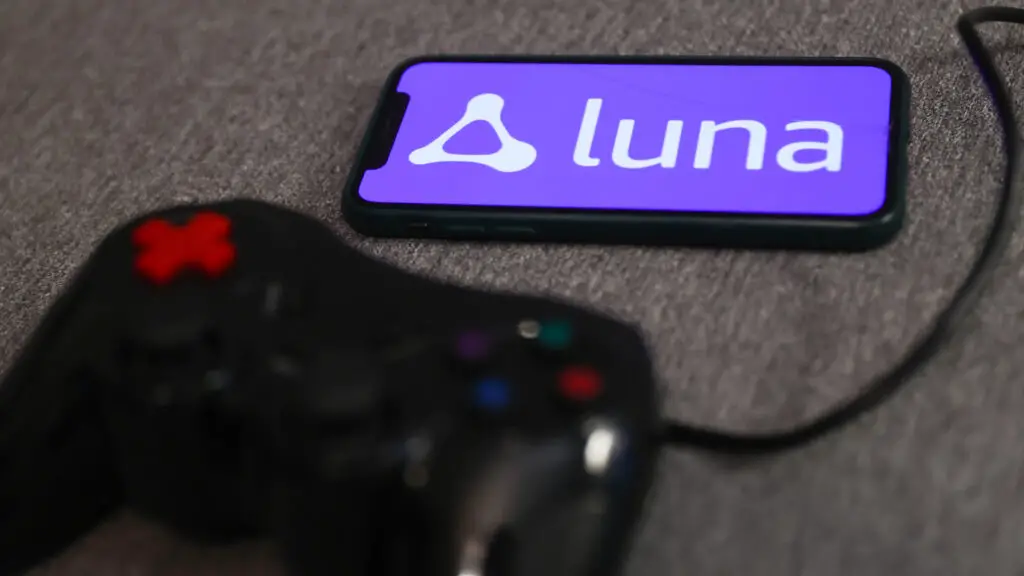 Luna logo displayed on a phone screen and a gamepad are seen in this illustration photo taken in Krakow, Poland on September 29, 2022. 