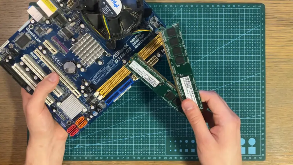 DDR2 RAM sticks next to an ASRock motherboard