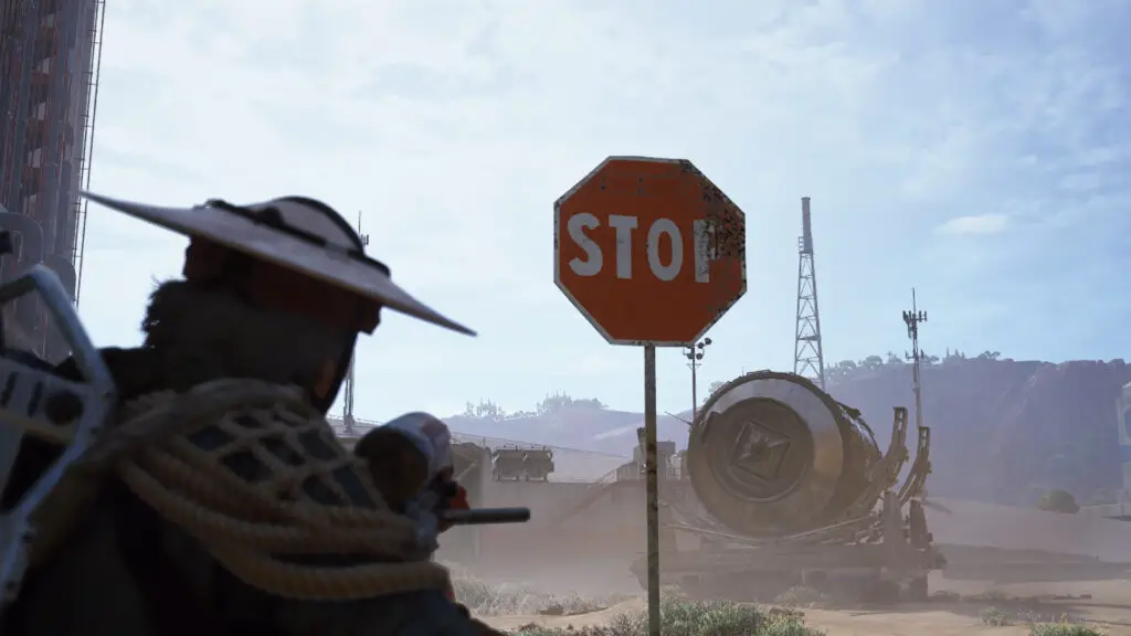A raider points their gun at a stop sign in Arc Raiders.