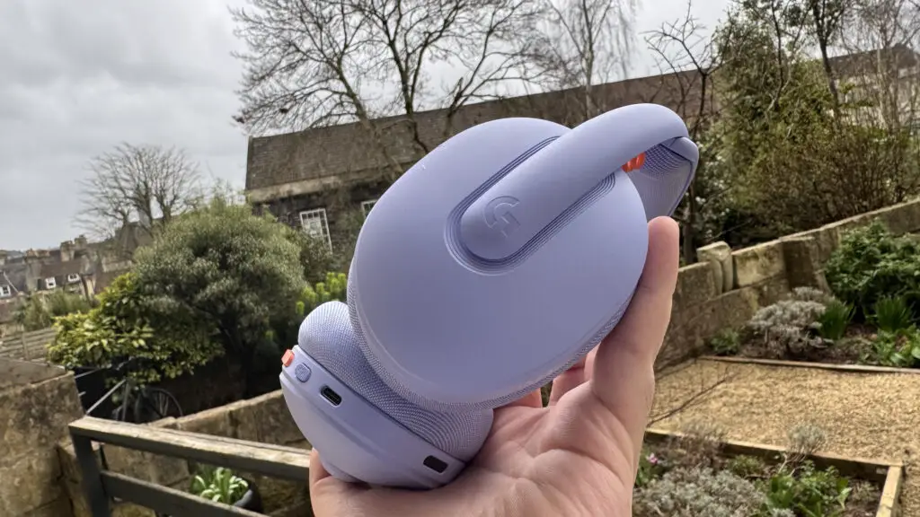 Logitech G325 Gaming headset in purple held outdoors