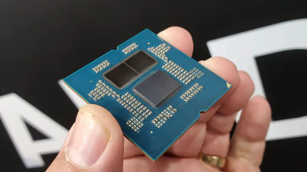 A delidded AMD Ryzen 9000 series processor showing the two CCD and one IOD chiplets